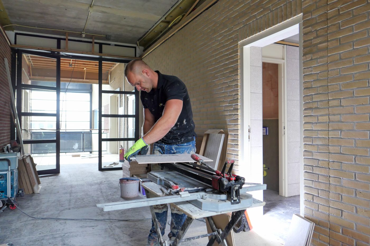 Tile being cut and fitted at Pulse
